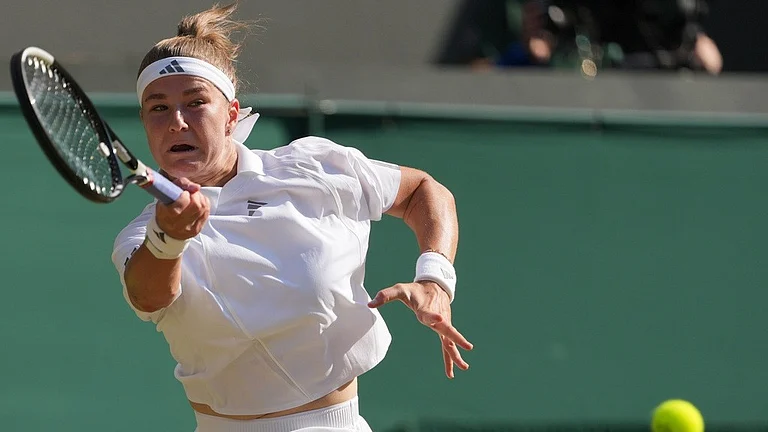 Karolina Muchova of Czech Republic returns the ball to Naomi Osaka of Japan in their quarter-final women's singles match at the Wimbledon Tennis Championships in London - AP Photo/Kin Cheung