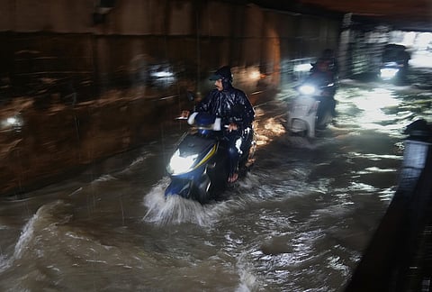 Motorists ride through a water-logged subway during monsoon rains in Mumbai, Monday, July 6, 2026. 