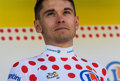 France's Alex Baudin wearing the best climber's dotted jersey celebrates on the podium after the third stage of the Tour de France cycling race with start in Granollers and finish in Les Angles , France, Monday, July 6, 2026.