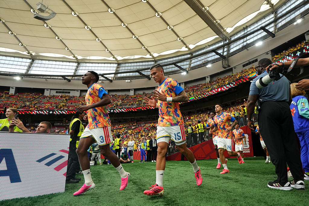Colombias Juan Portilla (15) and Jhon Lucumí (3) run onto the field before the World Cup round of 16 soccer match between Switzerland and Colombia in Vancouver, British Columbia