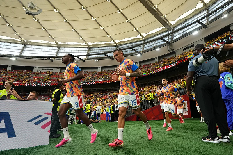 Colombias Juan Portilla (15) and Jhon Lucumí (3) run onto the field before the World Cup round of 16 soccer match between Switzerland and Colombia in Vancouver, British Columbia