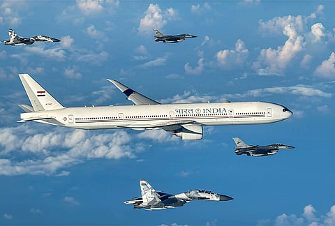 An airplane carrying Prime Minister Narendra Modi, unseen, being escorted by fighter jets at the Indonesian Air Force Halim Perdanakusuma Air Base, Jakarta, Indonesia. 