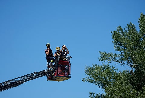 Firefighters watch riders during the third stage of the Tour de France cycling race with start in Granollers and finish in Les Angles, France, Monday, July 6, 2026.