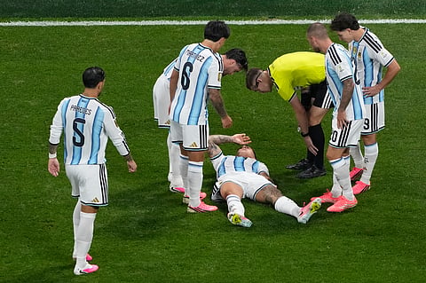 Players check on Argentina's Enzo Fernandez (24) during the World Cup round of 16 soccer match between Argentina and Egypt in Atlanta, Tuesday, July 7, 2026.