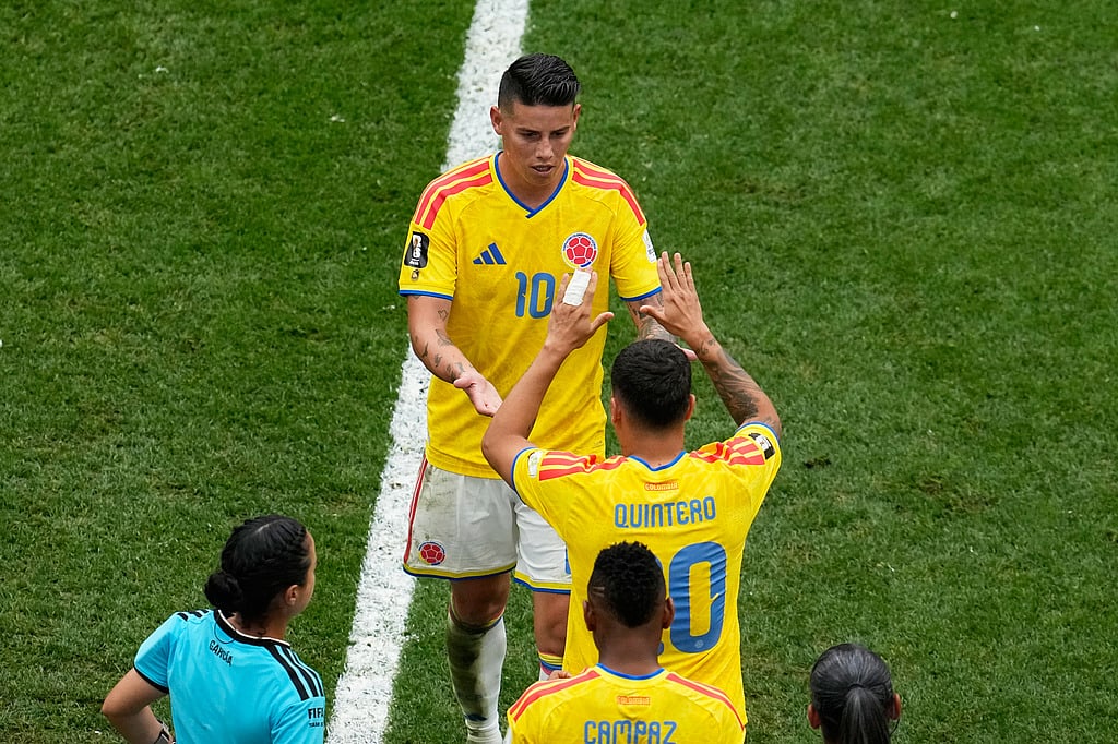 Colombias James Rodriguez (10) is greeted by Juan Quintero (20) as he is substituted during the World Cup round of 16 soccer match against Switzerland in Vancouver, British Columbia