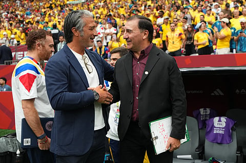 Switzerland's Murat Yakin, left, and Colombia's Néstor Lorenzo meet before the World Cup round of 16 soccer match between Switzerland and Colombia in Vancouver, British Columbia