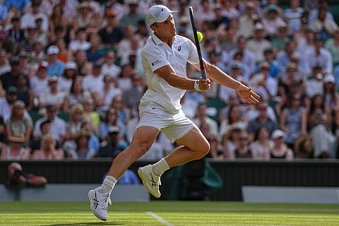 Arthur Fery of Britain plays a return during the men's singles fourth round match against Grigor Dimitrov of Bulgaria at the Wimbledon Tennis Championships in London.
