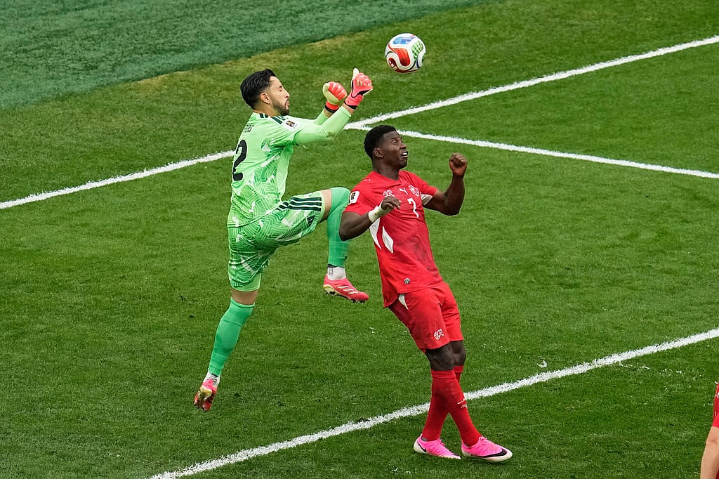 Colombia goalkeeper Camilo Vargas (12) collides with Switzerlands Breel Embolo (7) while making a save during the World Cup round of 16 soccer match in Vancouver, British Columbia