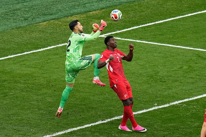 Colombia goalkeeper Camilo Vargas (12) collides with Switzerlands Breel Embolo (7) while making a save during the World Cup round of 16 soccer match in Vancouver, British Columbia