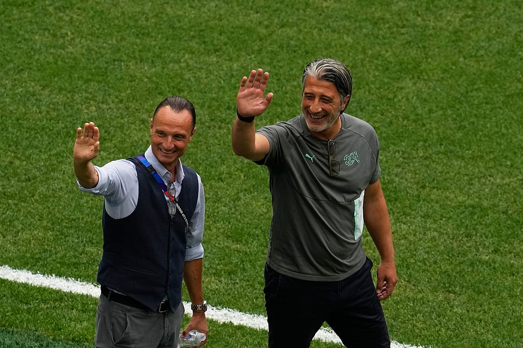 Switzerland head coach Murat Yakin, right, waves on the pitch before their World Cup round of 16 soccer match against Colombia in Vancouver, British Columbia