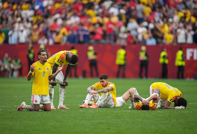 Colombias Daniel Munoz (2) kneels on the field with his collapsed teammates after losing to Switzerland in a penalty kick shootout in the World Cup round of 16 soccer match between Switzerland and Colombia in Vancouver, British Columbia