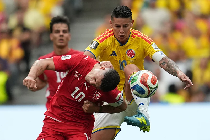 Switzerlands Granit Xhaka (10), left, and Colombias James Rodriguez (10) fight for the ball during the World Cup round of 16 soccer match between Switzerland and Colombia in Vancouver