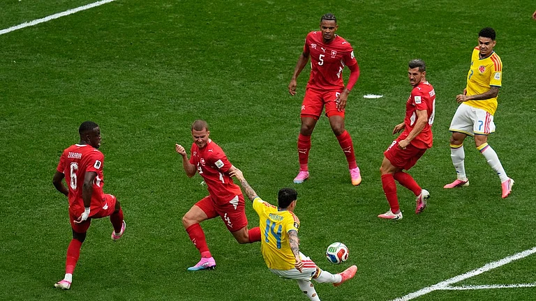Colombia's Gustavo Puerta (14) takes a shot on goal against Switzerland during the World Cup round of 16 soccer match in Vancouver, British Columbia. - Gregory Bull/AP Photo