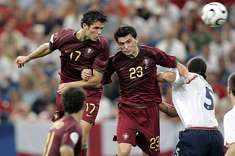 Portugal's Cristiano Ronaldo, left, and Helder Postiga jump for the ball against England's Rio Ferdinand during a World Cup quarterfinal soccer match in Gelsenkirchen, Germany, July 1, 2006.