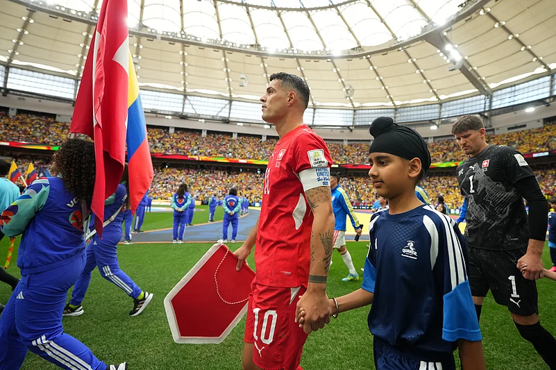 Switzerlands Granit Xhaka walks onto the field before the World Cup round of 16 soccer match between Switzerland and Colombia in Vancouver, British Columbia