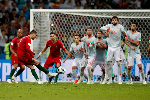 Portugal's Cristiano Ronaldo kicks to score his side's equalizing goal during the group B World Cup match between against Spain in Sochi, Russia, Friday, June 15, 2018.