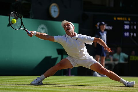 Arthur Fery of Britain plays a return during the men's singles fourth round match against Grigor Dimitrov of Bulgaria at the Wimbledon Tennis Championships in London.
