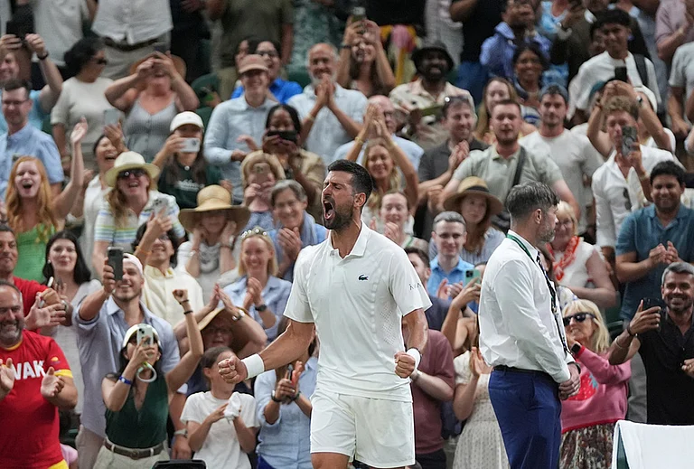 Novak Djokovic of Serbia celebrates winning against Felix Auger-Aliassime of Canada in their quarter-final men's singles match at the Wimbledon Tennis Championships in London, Tuesday, July 7, 2026. - | Photo: AP/Maja Smiejkowska