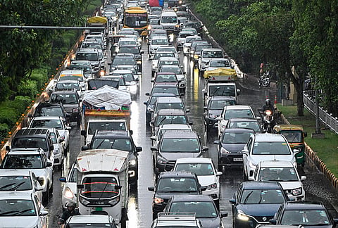 Vehicles ply on a road amid rain, in Noida, Tuesday, July 7, 2026. 