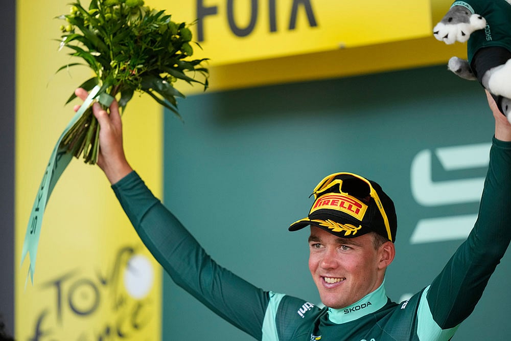 Denmark's Mads Pedersen wearing the best sprinter's green jersey celebrates on the podium after winning the fourth stage of the Tour de France cycling race with start in Carcassonne and finish in Foix, France. - | Photo: AP/Thibault Camus