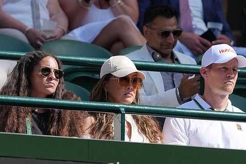 Tamaki Osaka, centre, watches her daughter Naomi Osaka of Japan play against Karolina Muchova of Czech Republic in their quarter-final women's singles match at the Wimbledon Tennis Championships in London.