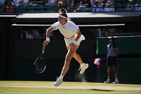 Karolina Muchova of Czech Republic serves against Naomi Osaka of Japan in their quarter-final women's singles match at the Wimbledon Tennis Championships in London.