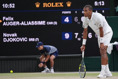 Felix Auger-Aliassime of Canada reacts after losing a point against Novak Djokovic of Serbia, as the match clock reaches five hours and 13 minutes, making it the longest Wimbledon men's singles quarterfinal in history, at the Wimbledon Tennis Championships in London, Tuesday, July 7, 2026. 