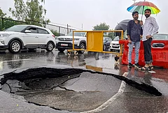 Vehicles move near a caved-in section of a road following monsoon rains, in Gurugram, Tuesday, July 7, 2026. - | Photo: PTI