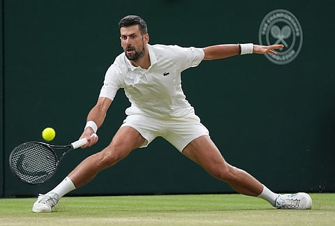 Novak Djokovic of Serbia returns the ball to Felix Auger-Aliassime of Canada in their quarter-final men's singles match at the Wimbledon Tennis Championships in London, Tuesday, July 7, 2026. 