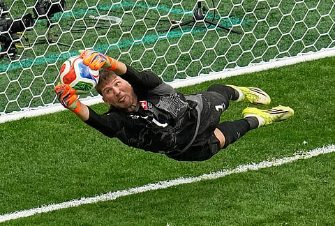 Switzerland goalkeeper Gregor Kobel (1) blocks a penalty shot by Colombia's Cucho Hernandez in a shootout during the World Cup round of 16 soccer match in Vancouver, British Columbia.