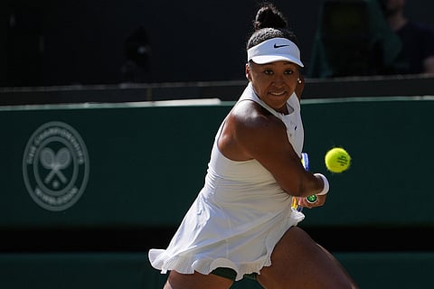Naomi Osaka of Japan returns the ball to Karolina Muchova of Czech Republic in their quarter-final women's singles match at the Wimbledon Tennis Championships in London.