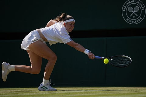Karolina Muchova of Czech Republic returns the ball to Naomi Osaka of Japan in their quarter-final women's singles match at the Wimbledon Tennis Championships in London.