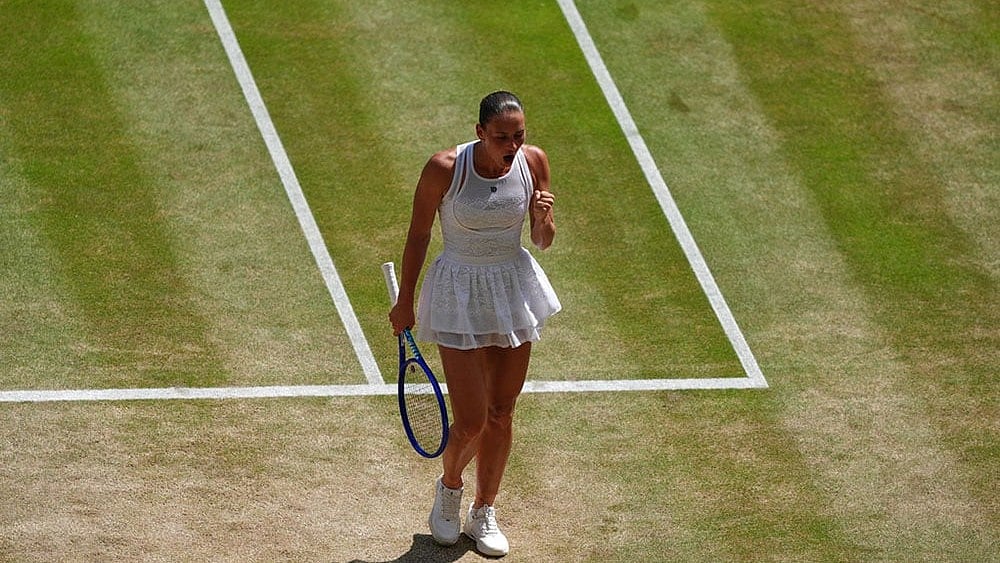 Marta Kostyuk of Ukraine reacts after winning a point against Jasmine Paolini of Italy in their quarter-final women's singles match at the Wimbledon Tennis Championships in London. - | Photo: AP/Maja Smiejkowska