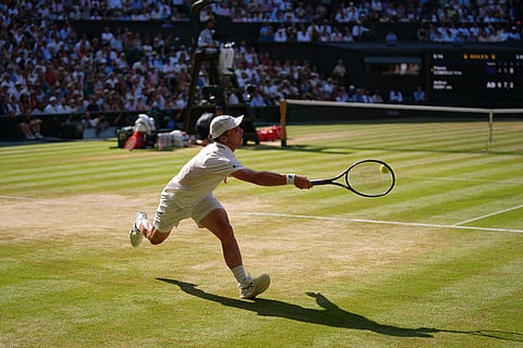 Arthur Fery of Britain returns the ball to Flavio Cobolli of Italy in their quarter-final men's singles match at the Wimbledon Tennis Championships in London.