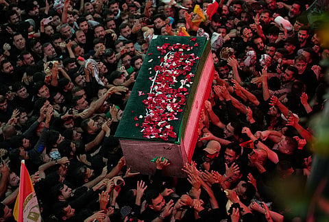 The coffin of the late Iranian Supreme Leader Ayatollah Ali Khamenei, covered with flower petals, is carried by mourners outside the Imam Hussein Shrine in Karbala, Iraq, early Thursday, July 9, 2026. 
