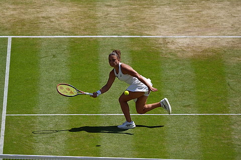 Jasmine Paolini of Italy returns the ball to Marta Kostyuk of Ukraine in their quarter-final women's singles match at the Wimbledon Tennis Championships in London.