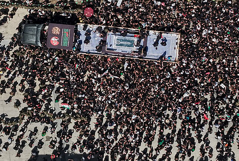 A truck carrying the coffin of the late Iranian Supreme Leader Ayatollah Ali Khamenei makes its way through mourners during a funeral procession in Najaf, Iraq, Wednesday, July 8, 2026. 