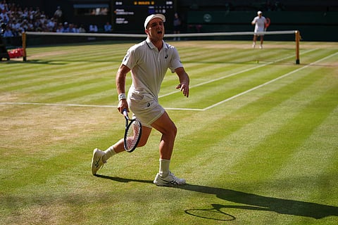 Arthur Fery of Britain reacts to losing a point against Flavio Cobolli of Italy, background, in their quarter-final men's singles match at the Wimbledon Tennis Championships in London.