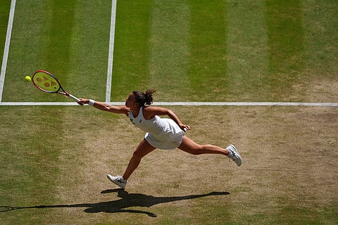 Jasmine Paolini of Italy returns the ball to Marta Kostyuk of Ukraine in their quarter-final women's singles match at the Wimbledon Tennis Championships in London.