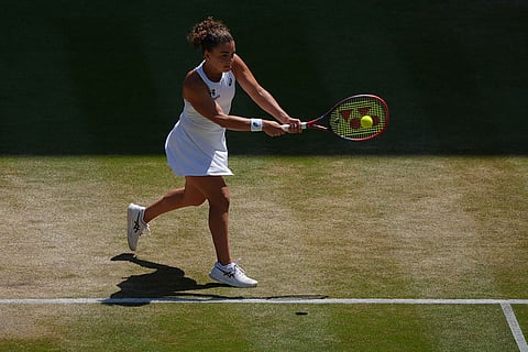 Jasmine Paolini of Italy returns the ball to Marta Kostyuk of Ukraine in their quarter-final women's singles match at the Wimbledon Tennis Championships in London.