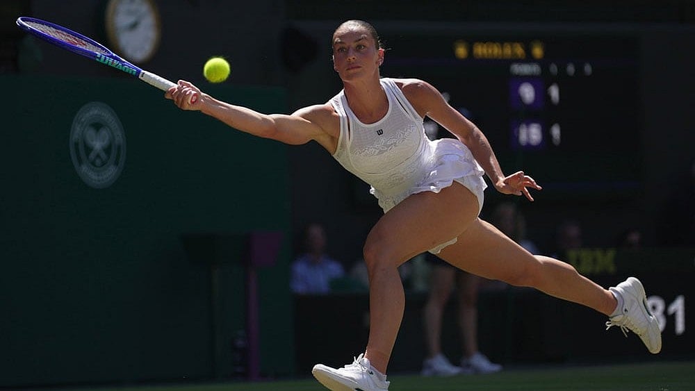 Marta Kostyuk of Ukraine returns the ball to Jasmine Paolini of Italy, in their quarter-final women's singles match at the Wimbledon Tennis Championships in London. - Photo: AP/Brian Inganga