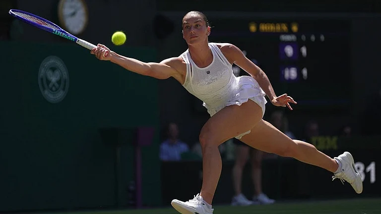 Marta Kostyuk of Ukraine returns the ball to Jasmine Paolini of Italy, in their quarter-final women's singles match at the Wimbledon Tennis Championships in London. - Photo: AP/Brian Inganga