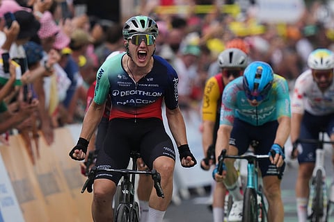 Netherland's Olav Kooij celebrates as he crosses the finish line to win the fifth stage of the Tour de France cycling race with start in Lannemezan and finish in Pau, France.