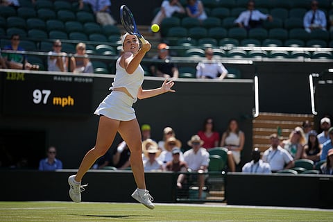 Linda Noskova of the Czech Republic returns the ball during the women's quarter-final singles match against Elise Mertens of Belgium at the Wimbledon Tennis Championships in London.
