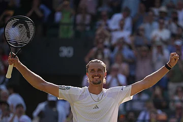 | Photo: AP/Kin Cheung : Alexander Zverev of Germany celebrates winning against Taylor Fritz of the United States in their quarter-final men's singles match at the Wimbledon Tennis Championships in London.
