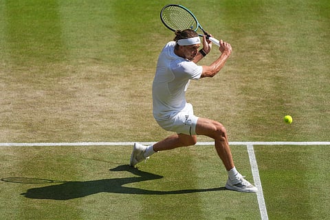 Alexander Zverev of Germany returns the ball during the men's singles quarter-final match against Taylor Fritz of the United States at the Wimbledon Tennis Championships in London.