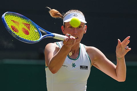 Elise Mertens of Belgium plays a return during the women's quarter-final singles match against Linda Noskova of the Czech Republic at the Wimbledon Tennis Championships in London.