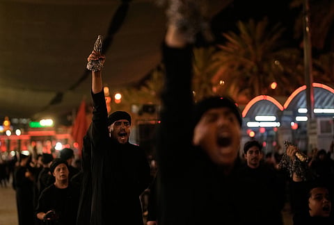 Shiite mourners chant slogans as the perform ritual self-flagellation with chains outside the Imam Hussein Shrine on the eve of funeral ceremonies for the late Iranian Supreme Leader Ayatollah Ali Khamenei in Karbala, Iraq, Tuesday, July 7, 2026.