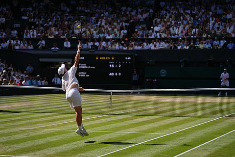 Arthur Fery of Britain serves to Flavio Cobolli of Italy in their quarter-final men's singles match at the Wimbledon Tennis Championships in London.