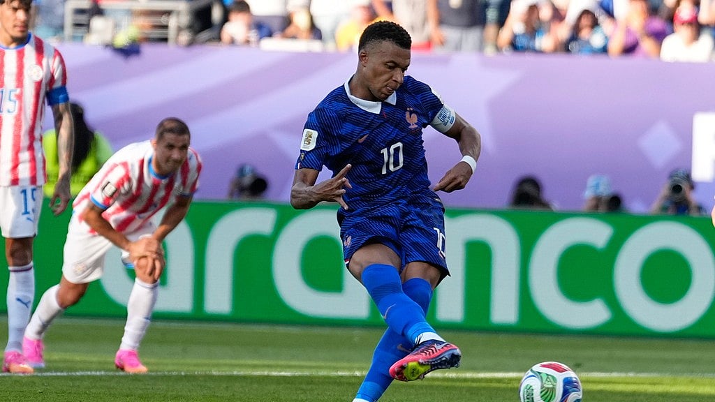 France's Kylian Mbappe scores from the penalty spot the opening goal during the World Cup round of 16 soccer match between Paraguay and France in Philadelphia - Matt Slocum/Ap Photo